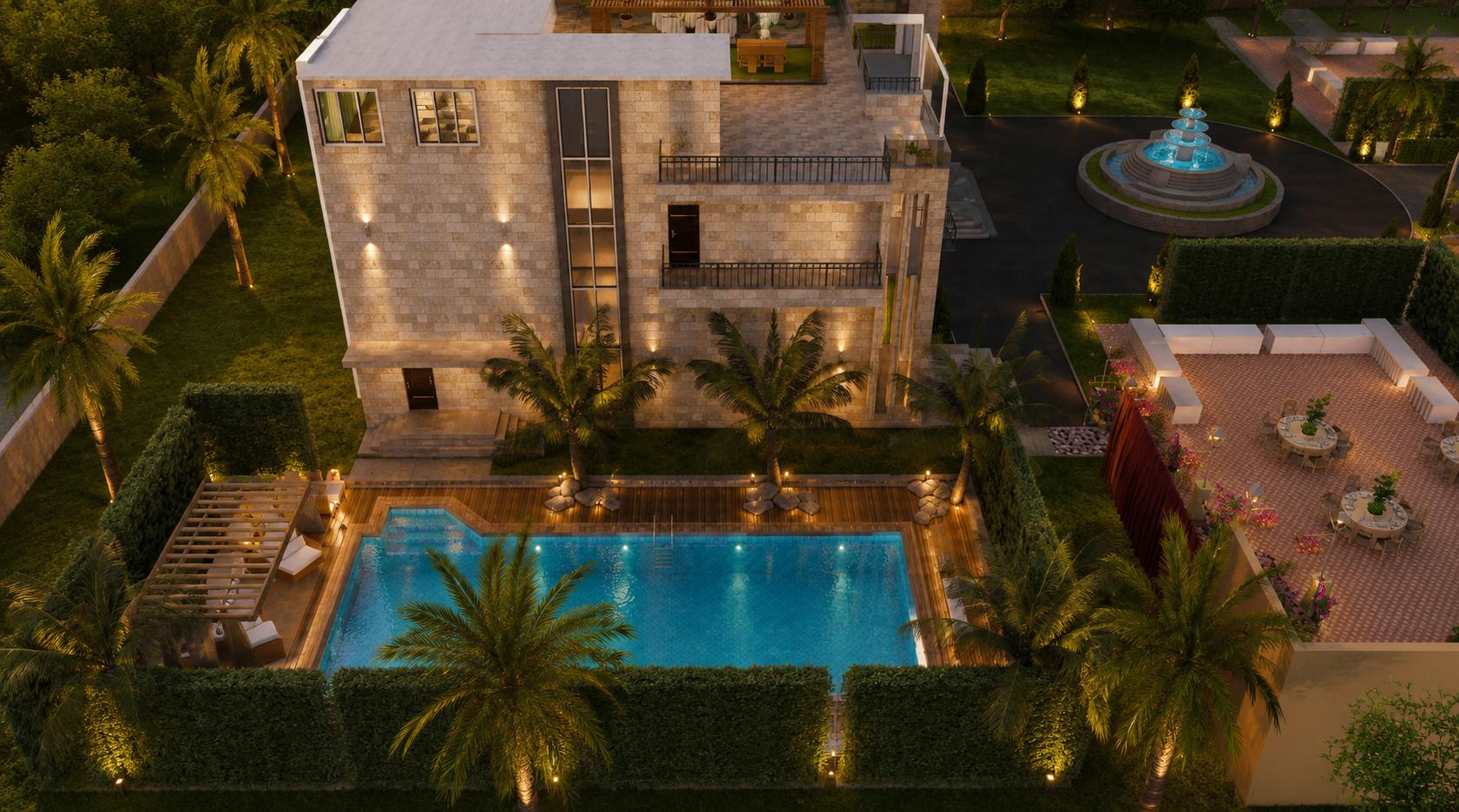 Aerial night view of the swimming pool ringed by palms and sun loungers